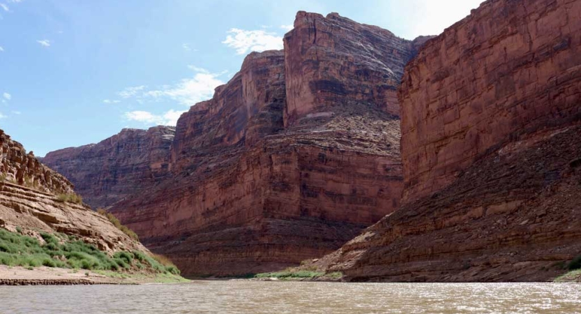 A river winds through tall red canyon walls